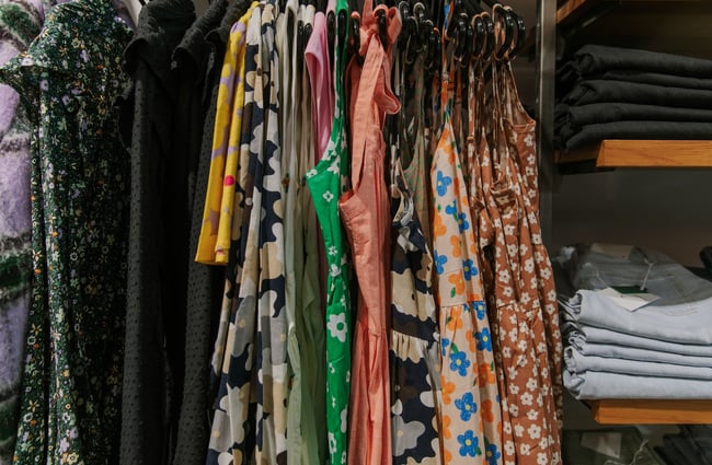 Close up of floral-patterned dresses hanging on a rack at Stencil.