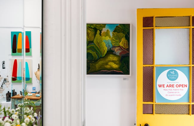 A yellow studio door open into the Studio Toru gallery.