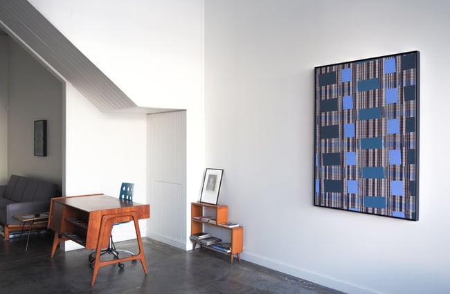 A blue and black artwork on the wall at Suite gallery Wellington.