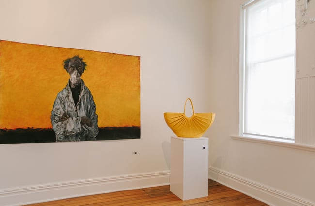 Yellow artwork with yellow handbag on plinth at Susan Badcock Gallery,  Geraldine.