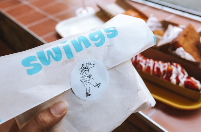 Close up image of the swings take away bags and their logo.