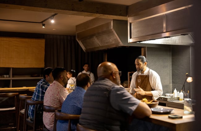 A chef serving customers at the Tala restaurant in Auckland.