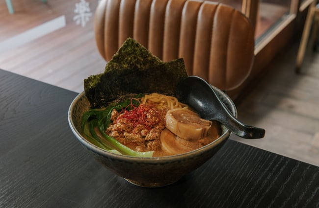 A bowl of ramen on a table.
