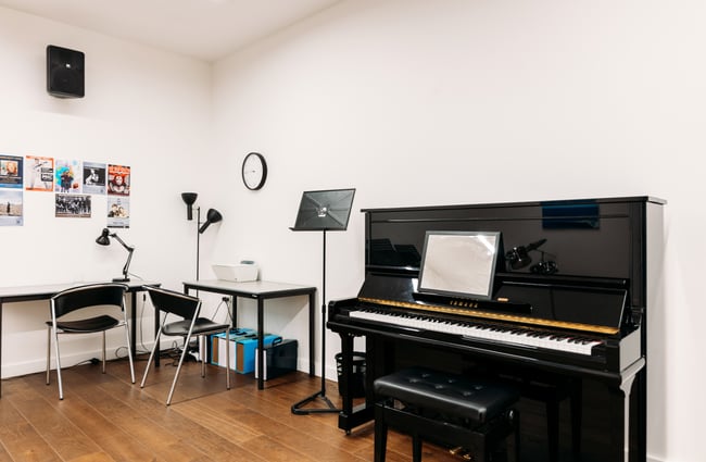 A piano and other musical instruments in a room.
