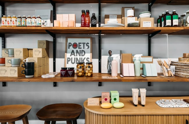 A close up of products on display on wooden shelves.