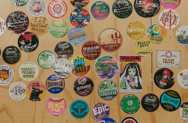 Beer stickers on a wall.