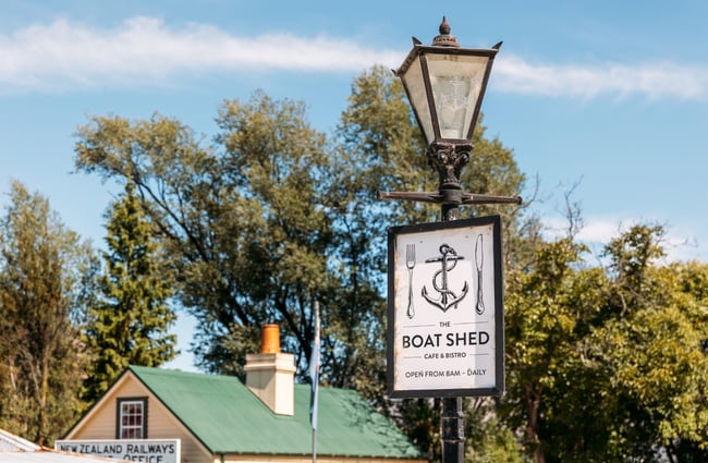 A 'Boat Shed' sign on a pole.