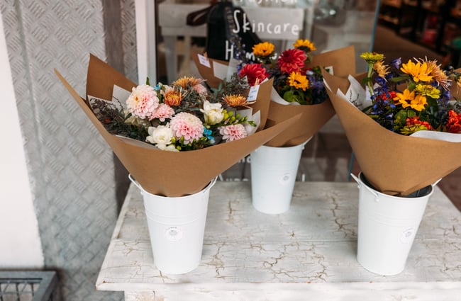 A close up of flower bouquets in pots.
