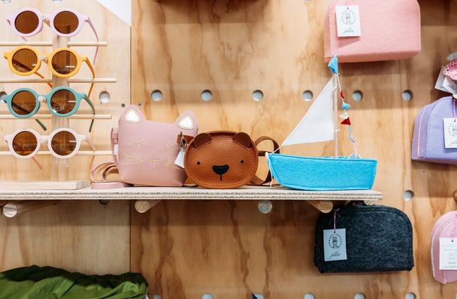 A close up of small colourful bags on shelves.