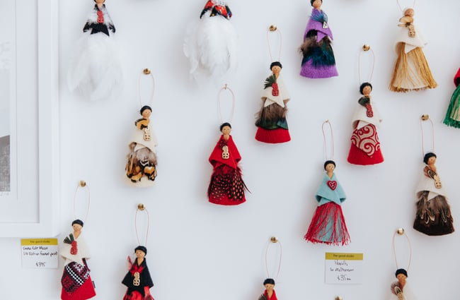 Close up of felt people on a wall.
