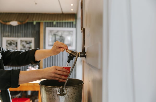 A drink being poured by a staff member at the Greedy Cow Café in Tekapo.