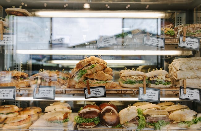 A close up of mega sandwiches inside full cabinet at The Greedy Cow Cafe in Tekapo.