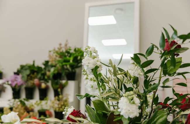 An image of the flower counter where black buckets of flowers are stored for bouquets.
