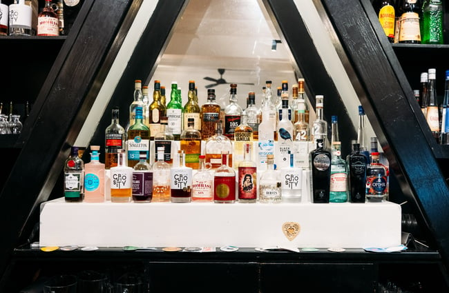 Bottles of liquor on display behind a bar.