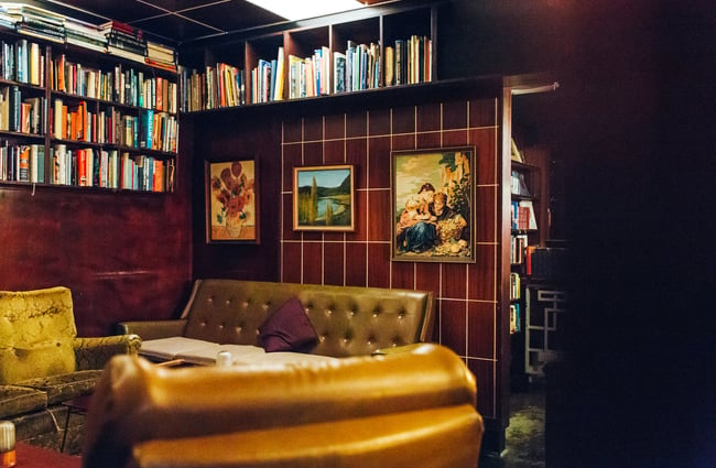 A seating area with vintage couches in The Library bar Wellington.