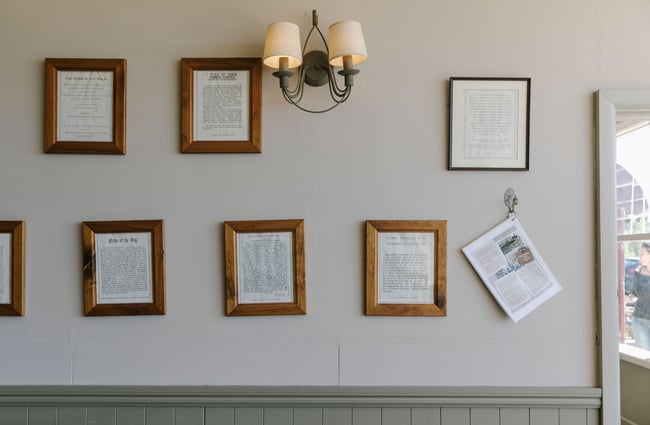 Pictures framed on the wall at The Moutere Inn, Nelson Tasman.