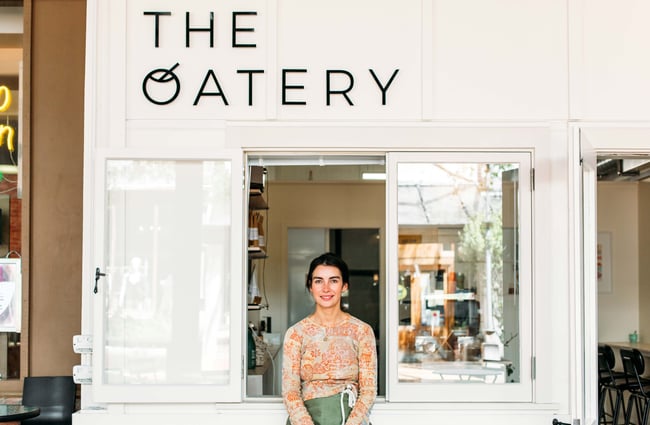 Owner, Anna, sat outside The Oatery.