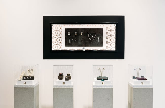 Jewellery on display on concrete plinths and hung on the wall inside Alice Herald.