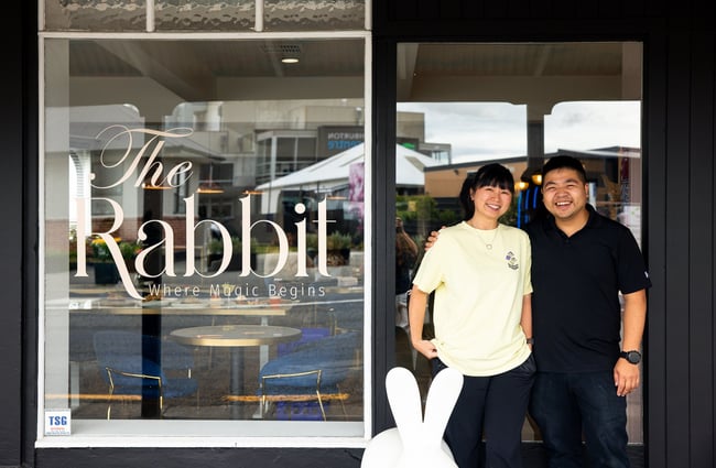 A man and woman standing in the entrance of The Rabbit restaurant, cafe and bar in Ashburton.