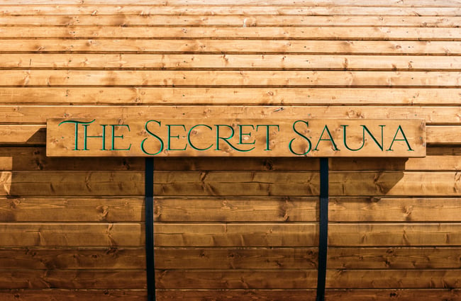 A close up of a sign on a sauna that says 'The Secret Sauna'.