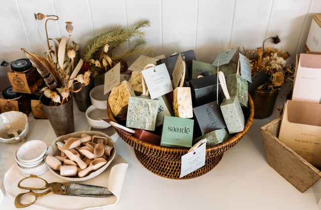 Close up of an assortment of soaps, wooden scoops and other pieces on display in The Workroom.