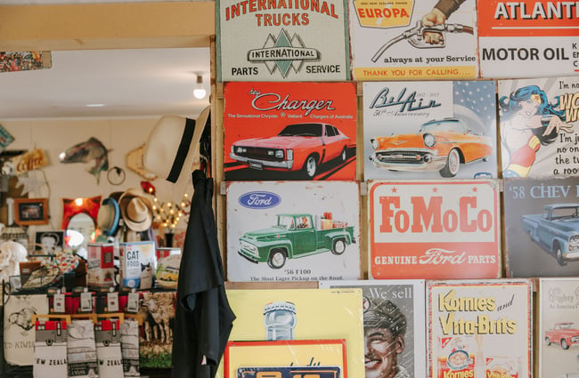 A close up of vintage signs on a wall at Three Creeks.