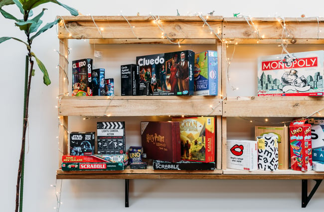 A close up of board games on shelves.