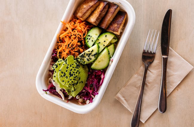 Close up of tofu salad in a compostable takeaway box