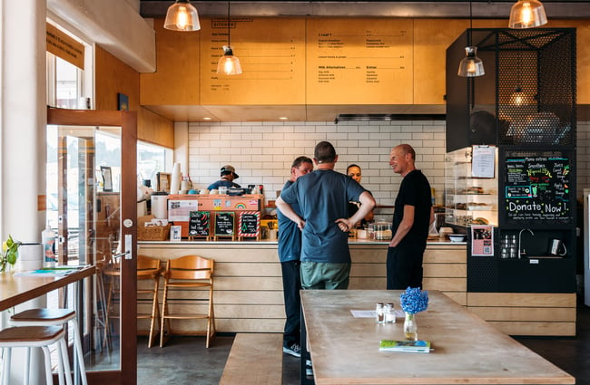 A group of three men ordering coffees at Trade School Kitchen cafe in Lower Hutt