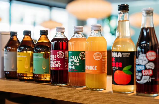 Range of local and organic juices lined up on shelf in cafe