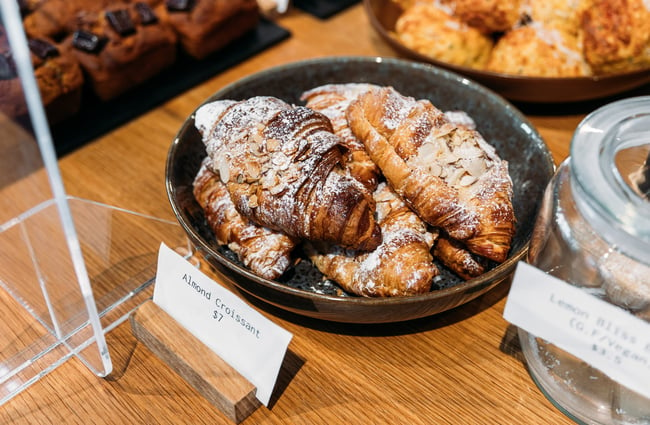 Plate of almond croissants in cafe cabinet