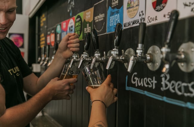 Beers being poured inside Two Thumb Manchester Street.