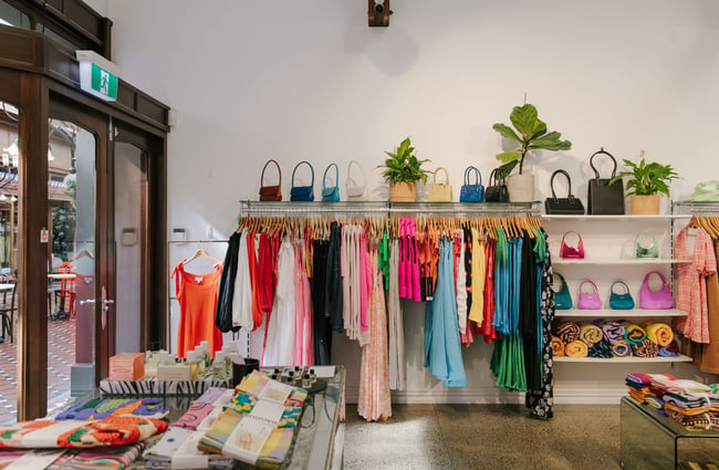 A wide view of colourful clothes on racks inside Uncommon store.