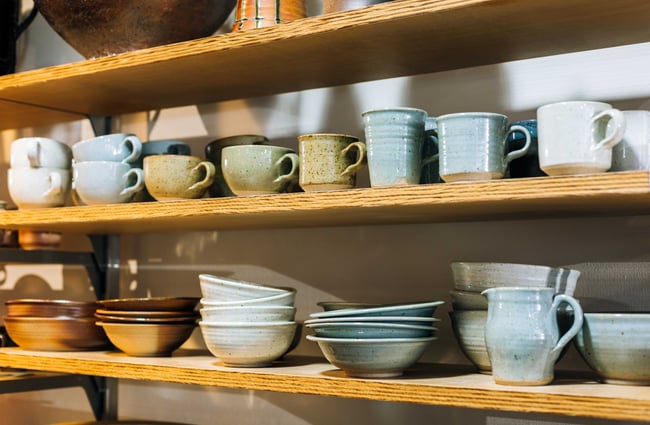 Ceramic homewares on a shelf.