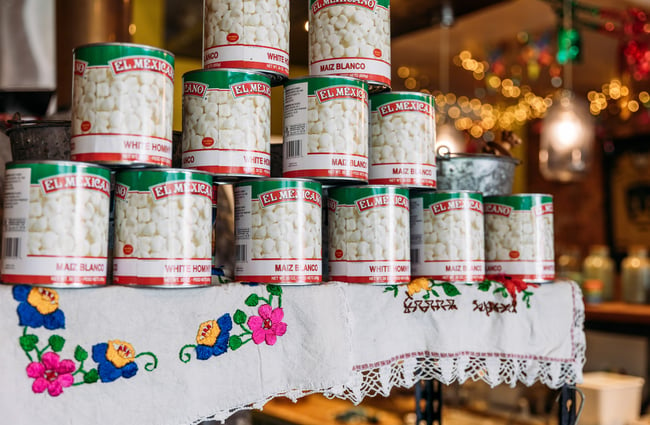 Close up of Mexican maiz blanco cans stacked on top of one another