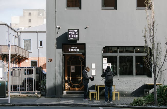 Two people standing outside Vogel Street Kitchen, Dunedin.