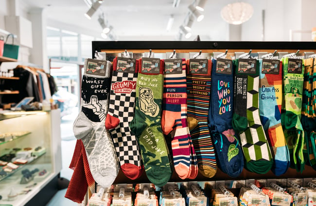 Socks lined up in rows on a display.