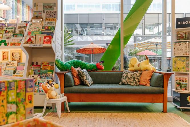 Reading corner at children's book shop with soft toy and books