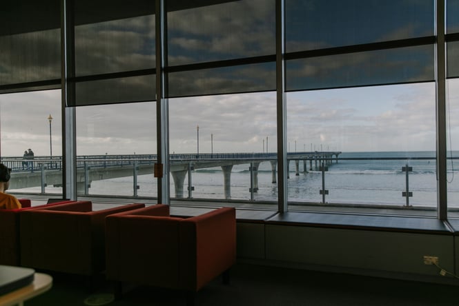 A view of the New Brighton pier from inside the New Brighton library.