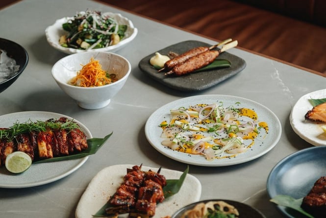 A table full of plates of food at Azabu.