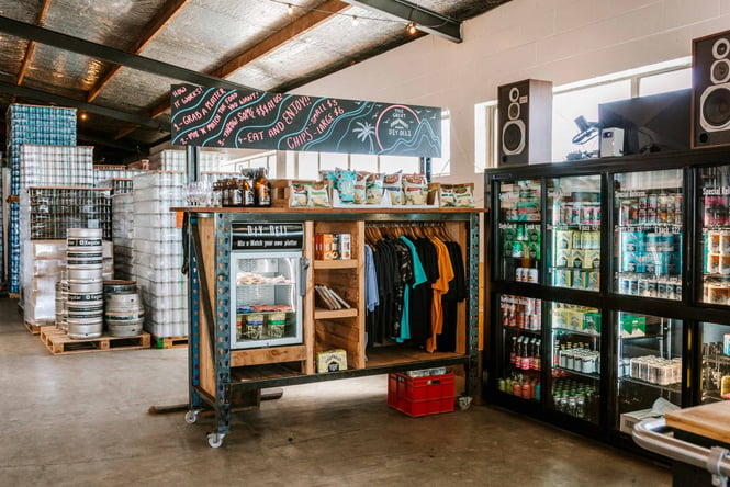 T-shirts and chilled drinks in a fridge inside Urbanaut in Auckland.