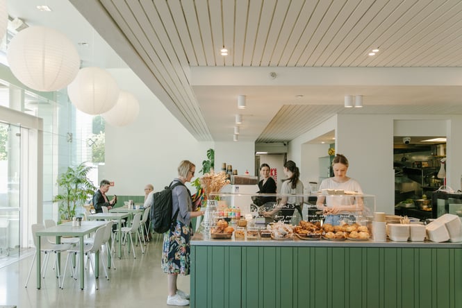 Green and white interior of Doubles in Christchurch with an overview of cabinet food