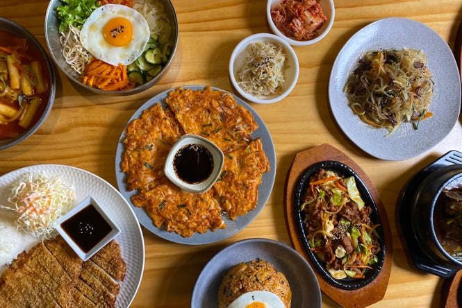 Table of plates full of Korean food at Gang Nam in Christchurch