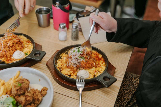 Two kimchi omelettes in a skillet on the table at Child Sister in Christchurch