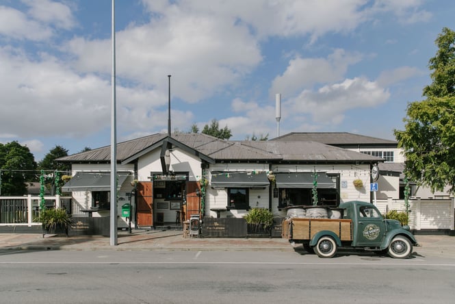 Exterior of The Dubliner Irish pub in Methven with farm truck parked outside