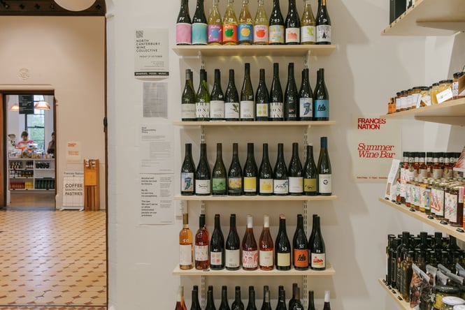 Bottles of wine on display on shelves inside Frances Nation.