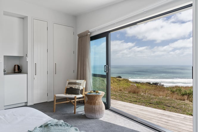 Bedroom at retreat in Auckland looking out towards the beach