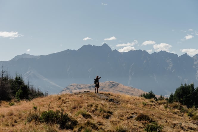 A person standing on the top of a hill in Queenstown.
