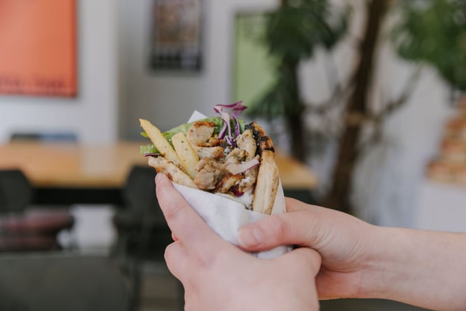Close up of a fresh souvlaki filled with chicken and fries