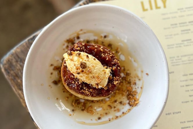 Plate of house crumpets with brown butter and a scoop of ice cream from Lily Eatery in Devonport Auckland